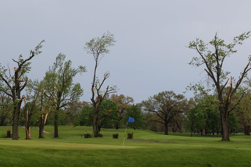 Damaged trees surround a flagstick at the Kankakee Elks Country Club on April 27, 2026. Some 300 trees were toppled or severely damaged by the March 10 tornado that hit Aroma Township, including the longtime golf course.