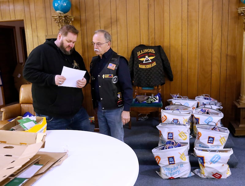 Tim Dempsey and Jim Wojtysiak talks about how they and other members of the Wauconda Masonic Lodge #298 will deliver the bags of groceries on Monday, Dec. 18, 2023, to about 45 McHenry County families, so they will have food for Christmas.