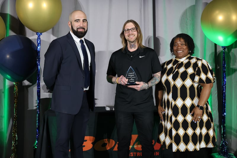 The 2026 Educator of the Year award was presented to Nic Schlichting (center) of Lake Bluff School District 65.