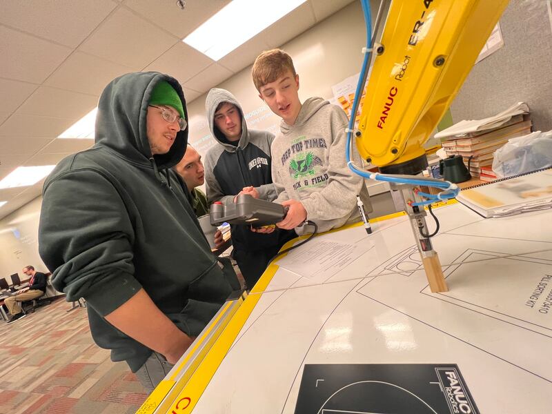 Yorkville High School received honors for its computer science, engineering, and biomedical programs. Pictured, Yorkville High School Engineering teacher, John Alaniz, helps students prepare for a class project.