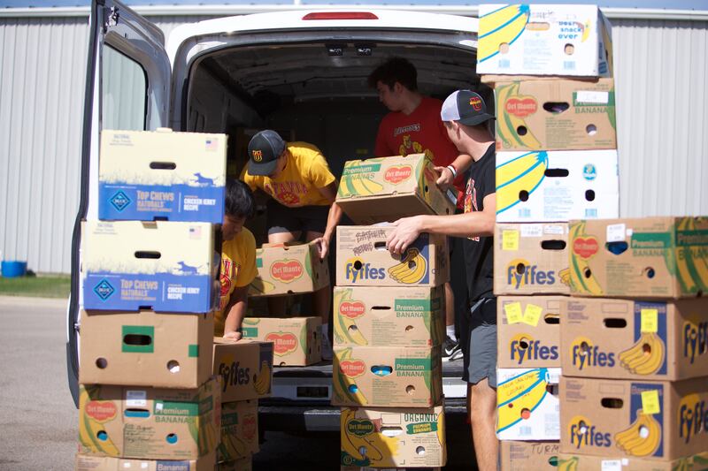 Batavia High School Football players help move boxes out of the former location of the Batavia Food Pantry on Saturday, Sept. 27,2025 in Batavia.
