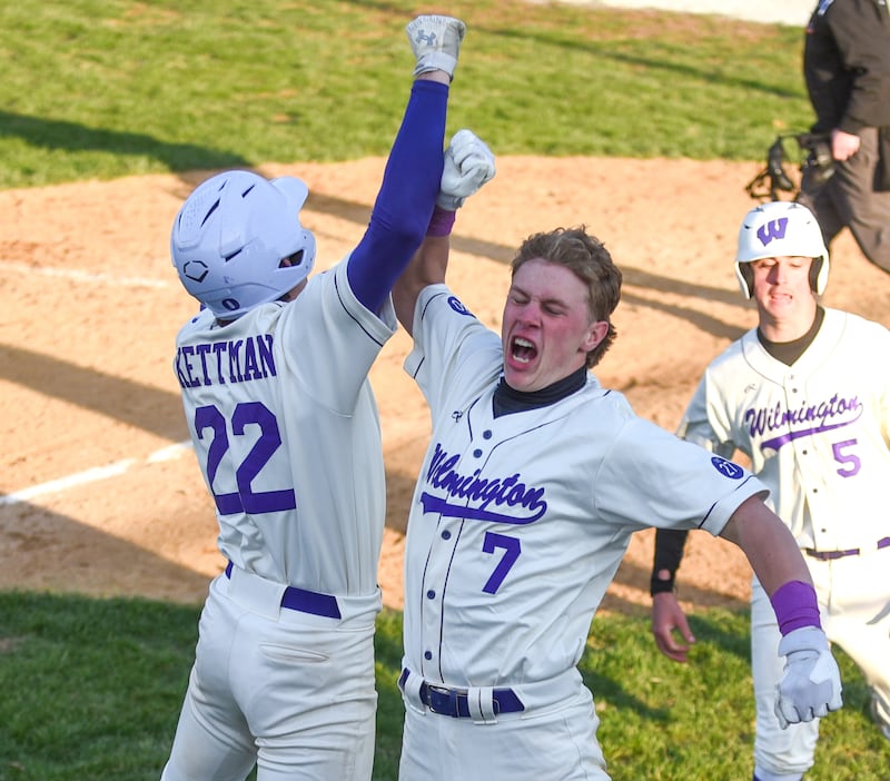 Wilmington's Cooper Holman, right, is congratulated by Ryan Kettman after hitting a grand slam during the Wildcats' 8-1 home win over Herscher Tuesday, April 7, 2026.