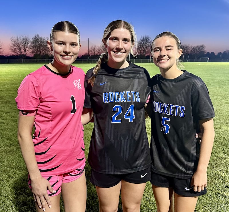 Kenzie Lorkowski (left) finished with nine saves, while Ali Kowall (center) assisted Grace Brown (right) in the 29th minute as Burlington Central held off Jacobs 1-0 on Tuesday night.