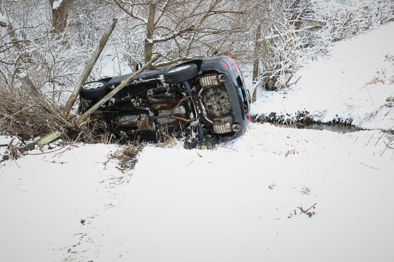 A car fell down an embankment near a creek Sunday, March 16, 2025, near Harvard.