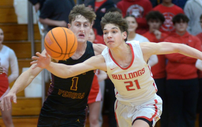 Streator’s Brennen Stillwell (21) knocks a pass away from East Peoria’s Jackson Ahrens (1) on Wednesday, Jan. 28, 2026, at Pops Dale Gymnasium in Streator.