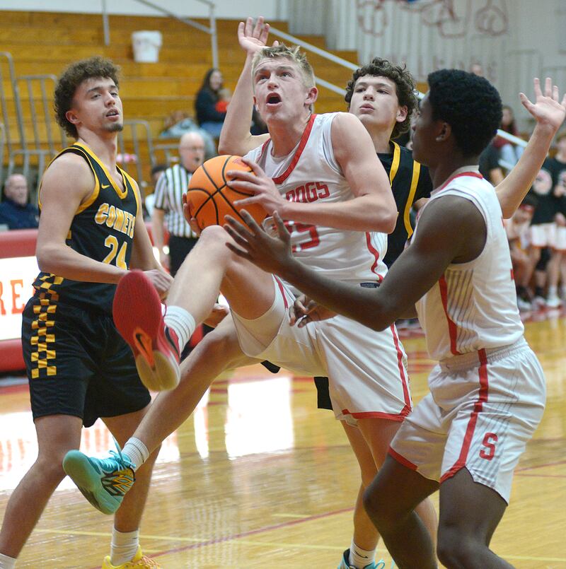 Streator’s Joe Hoekstra (25) gathers an offensive rebound in front of Reed-Custer's Colton Waldvogel (24) and prepares to go back up with a putback in a game earlier this season at Streator's Pops Dale Gymnasium.