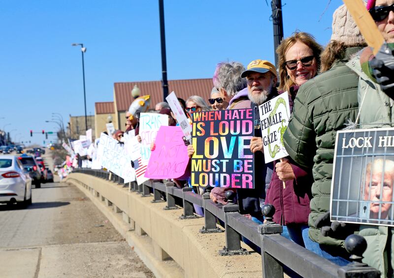 Hundreds of people – mostly women – filled the walkways across the Fox River on Illinois Route 38 in Geneva, spilling over to the sidewalks on either side on Saturday, March 8, 2025 in honor of International Women’s Day.