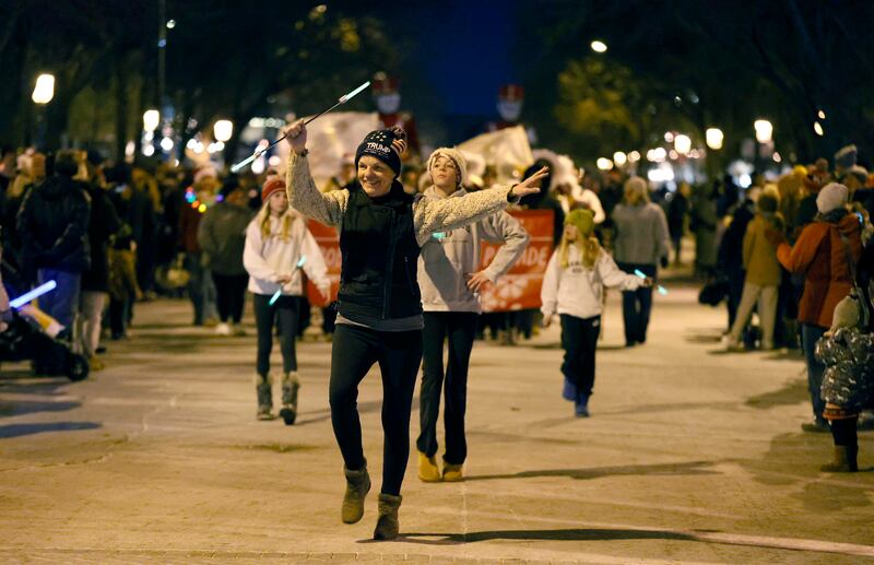 Joy Nelson of Geneva spins her baton during the annual Christmas Walk Friday, Dec. 6, 2024 in Geneva.