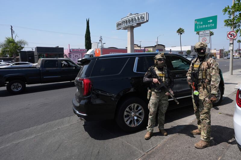 FILE - Immigration agents conduct an operation at a car wash Aug. 15, 2025, in Montebello, Calif. (AP Photo/Gregory Bull, File)