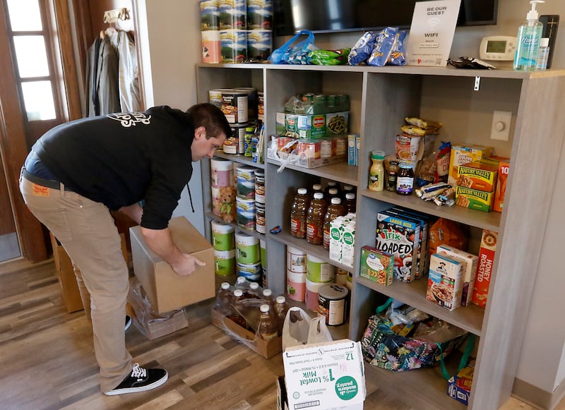 Jon Durdan of Warp Corps stocks the former shop for homeless and low income people in the Woodstock Depot on Wednesday, Oct. 23, 2024, in Woodstock. The shop is now located at 722 East Calhoun Street Unit 1.