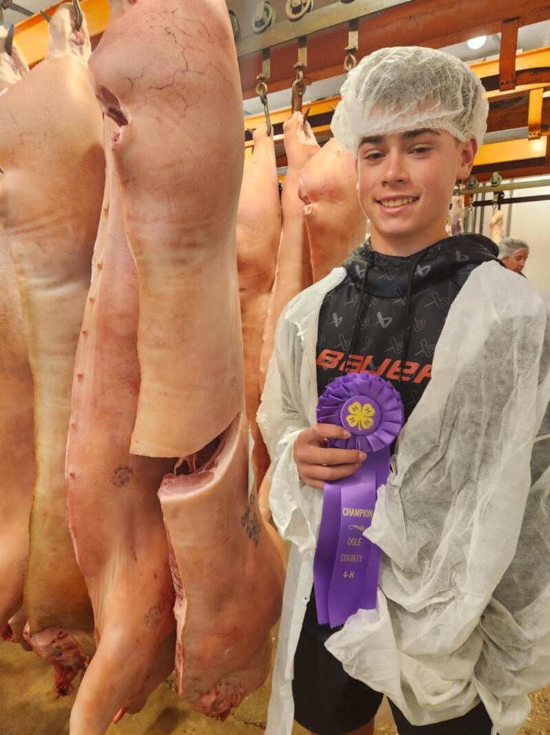 Grady Poliska stands with his Champion Pork Carcass at the Quality Meats Show, held in Seward at Eickman’s Processing Co.