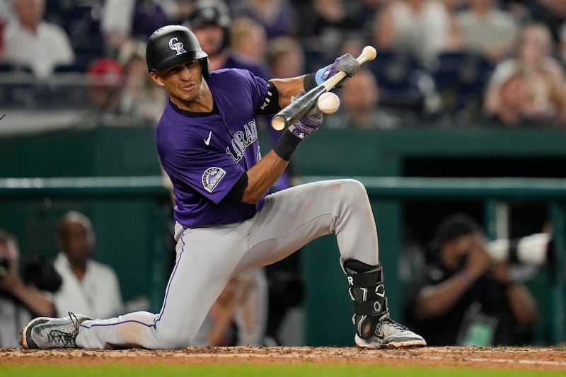 Colorado Rockies' Ryan Ritter hits a sacrifice bunt against the Washington Nationals during the seventh inning of a baseball game at Nationals Park, Wednesday, June 18, 2025, in Washington. (AP Photo/Jess Rapfogel)