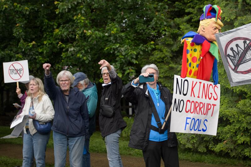 Demonstrators protest near Trump National Golf Club Washington DC before the arrival of President Donald Trump in Sterling, Va., Thursday, May 22, 2025. (AP Photo/Rod Lamkey, Jr.)