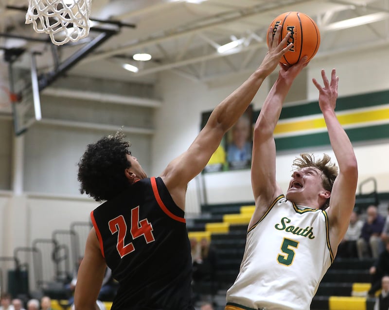 McHenry's Adam Anwar blocks the shot of Crystal Lake South's Carson Trivellini during a Fox Valley Conference boys basketball game on Wednesday, Jan. 14, 2026, at Crystal Lake South High School.