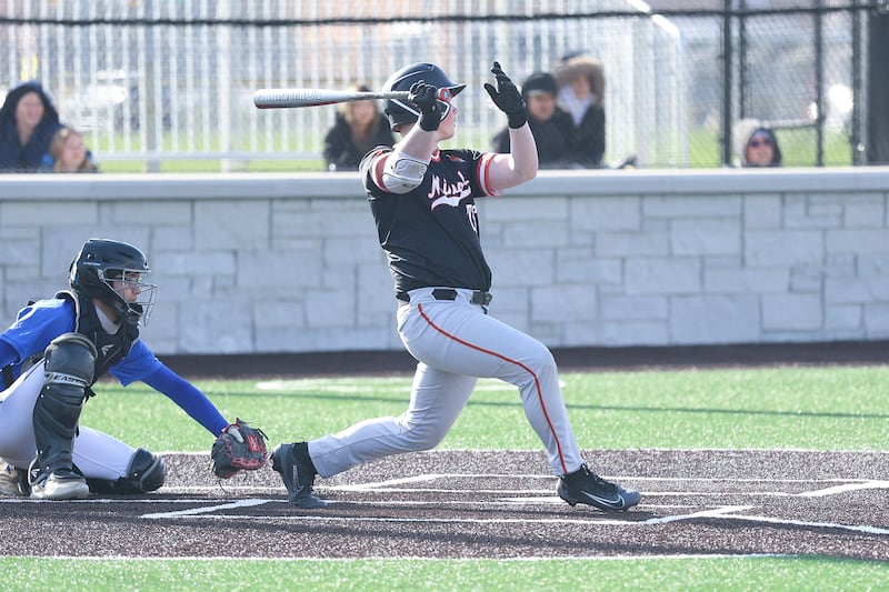 Minooka’s Conor Powers drives in a run against Joliet Central on Monday, April 6, 2026 in Joliet.