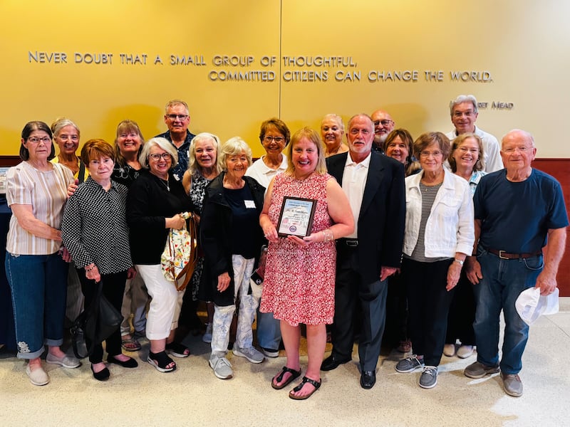 Joanie and Dan Britton (center) with their friends and family of St. Olaf Church in Montgomery show off their "Community Impact" award during the 2026 Volunteer of the Year ceremony in Montgomery on June 8, 2026.