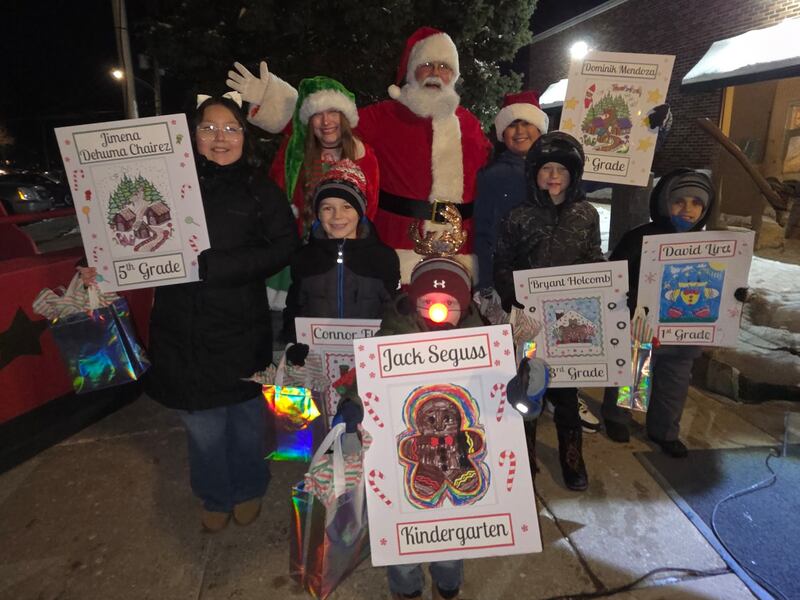 Winners of the Genoa Area Chamber of Commerce's annual coloring contest with elementary school students pose with Santa Claus at the chamber's Celebrate the Season event on Dec. 5, 2025. Pictured (from left) are 5th grader Jimena Dehuma Chairez, 2nd grader Connor Flury, kindergartener Jack Seguss, 4th grader Dominik Mendoza, 3rd grader Bryant Holcomb and 1st grader David Lira.