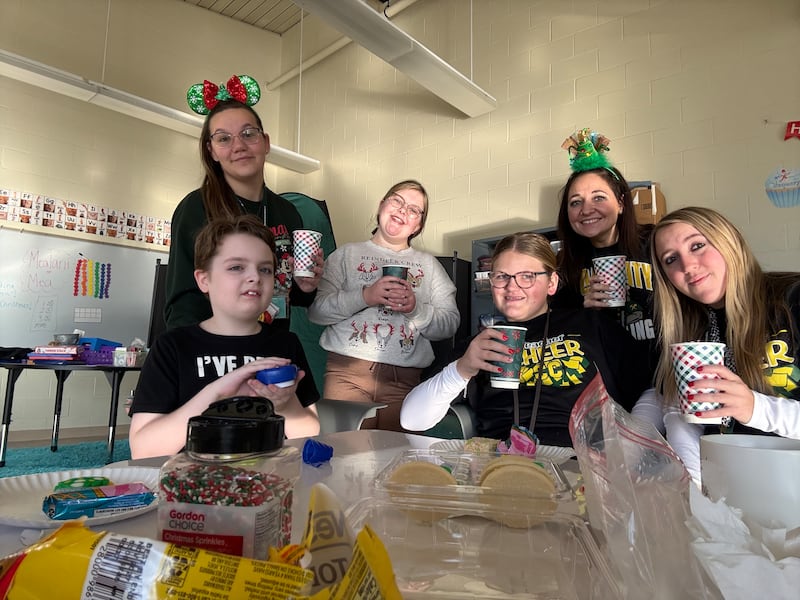 Gina Pens, a 2026 Shaw Local Everyday Hero (right) is seen with students from the classroom of Angela Roudis (left to Pens), a sixth-to eighth-grade teacher in the Cross-Categorical program at Coal City Middle School, where Pens works as a paraprofessional.