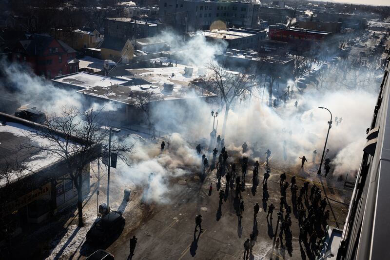 Federal agents deploy tear gas and other munitions into a crowd of people near the intersection of 27th Street and Nicollet Avenue in Minneapolis after a federal officer shot and killed 37-year-old Alex Pretti on Saturday, Jan. 24, 2026. (Ben Hovland/Minnesota Public Radio via AP)