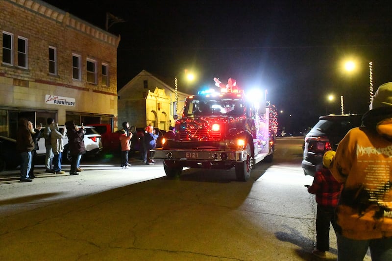 Santa Claus arrives atop a firetruck to downtown Herscher on Friday during the 29th Christmas in Herscher celebration.