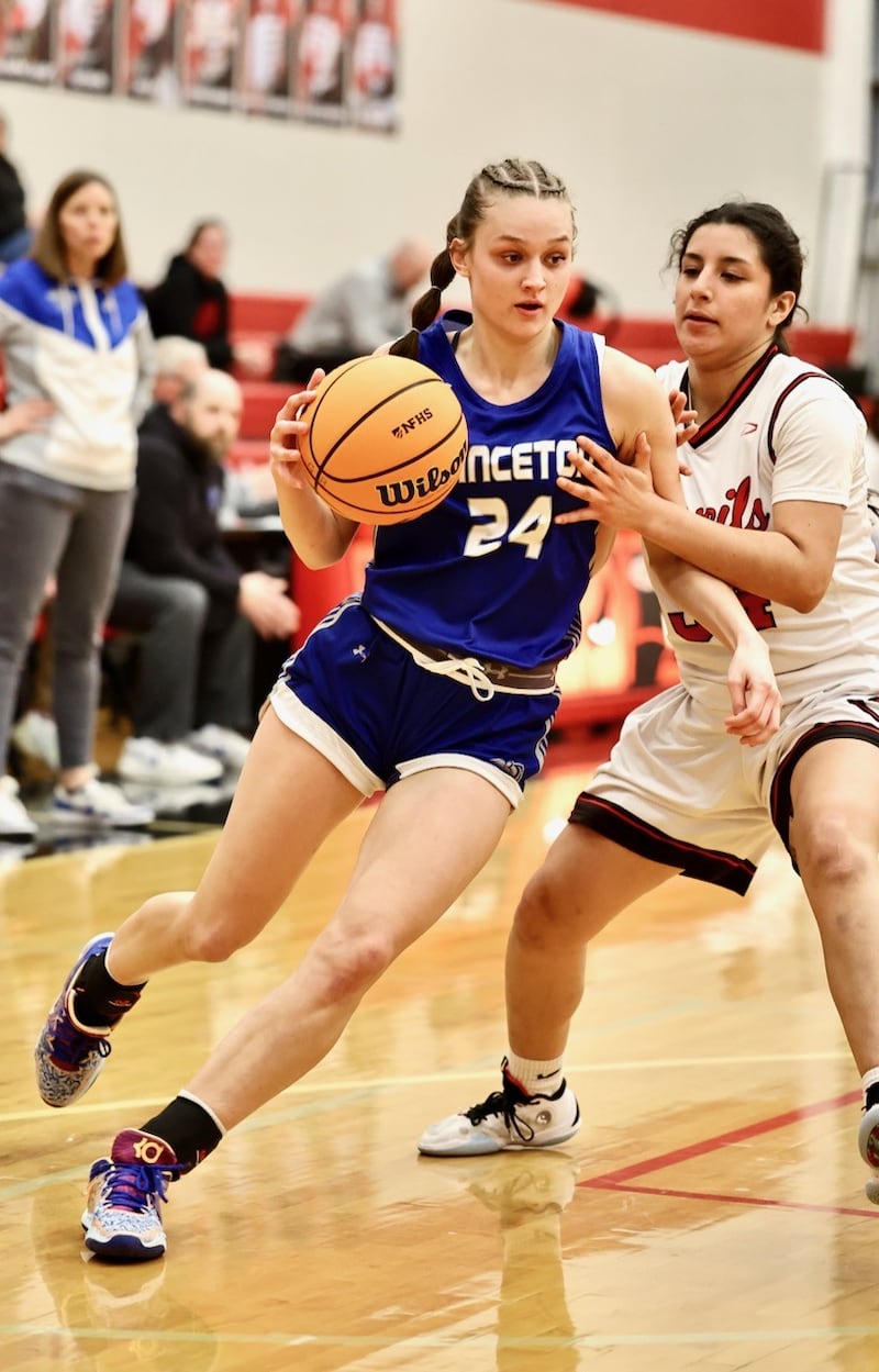 Princeton's Keighley Davis (left) drives past Hall's Natalia Zamora Thursday night in Spring Valley. The Tigresses won 48-28.