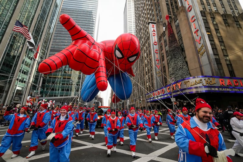 Balloon handlers guide the Spider Man balloon past Radio City Music Hall during the Macy's Thanksgiving Day Parade, Thursday, Nov. 27, 2025, in New York. (AP Photo/Eduardo Munoz Alvarez)