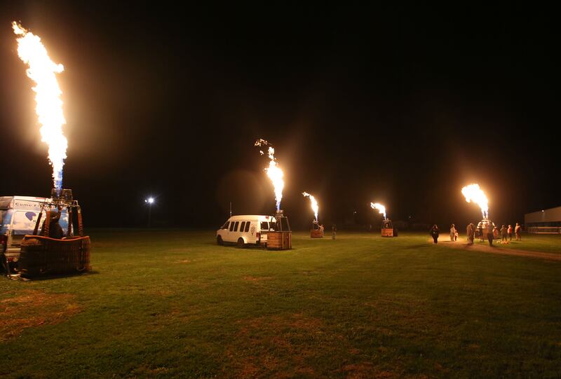 Hot air balloon companies ignite their flames all at once during the Monster Mash Balloon Bash on Saturday, Oct. 12, 2024 at the Bureau County Fairgrounds in Princeton. Inclement weather halted the balloons to fly.