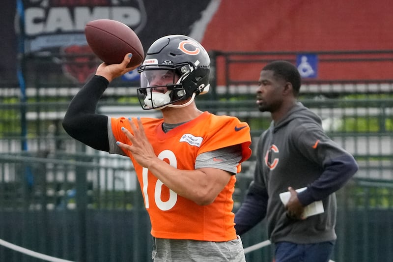 Chicago Bears quarterback Caleb Williams (18) throws the ball at practice during Back Together training camp event for fans on Saturday, July 26, 2025, in Lake Forest, Ill.  (AP Photo/David Banks)