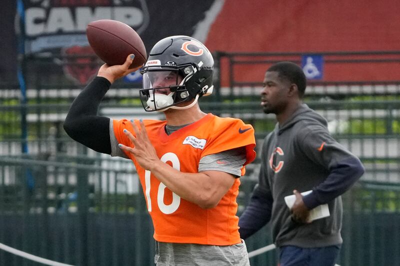 Chicago Bears quarterback Caleb Williams (18) throws the ball at practice during Back Together training camp event for fans on Saturday, July 26, 2025, in Lake Forest, Ill. (AP Photo/David Banks)