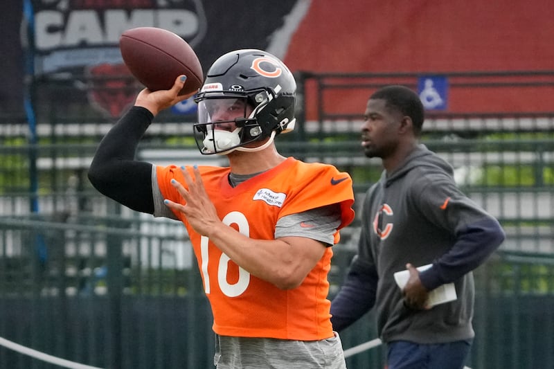 Chicago Bears quarterback Caleb Williams (18) throws the ball at practice during Back Together training camp event for fans on Saturday, July 26, 2025, in Lake Forest, Ill. (AP Photo/David Banks)