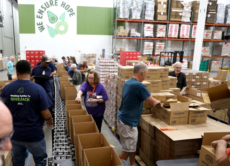 Volunteers help assemble holiday meal boxes on Tuesday, Oct. 29, 2024 at the Northern Illinois Food Bank in Geneva. This year marks the 25th anniversary of Northern Illinois Food Bank's Holiday Meal Box program.