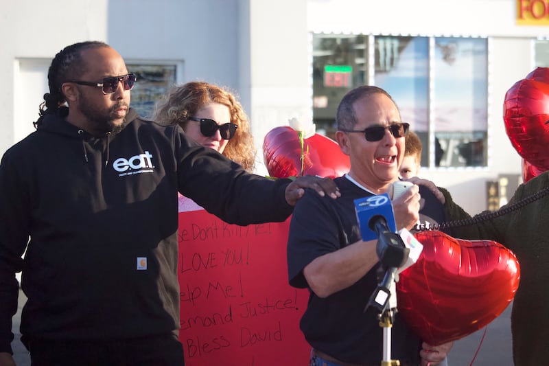 Former Joliet Township Trustee Karl Ferrell (left), comforts David Palacios, the father of David Malito, 39, at a prayer vigil and protest for Malito on Monday, May 5, 2025, at the Shell gas station, 401 S. Larkin Avenue, Joliet.