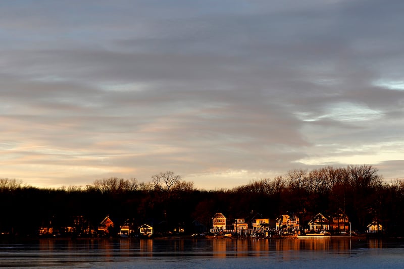 A band of sunlight lights up homes on Wednesday, Jan. 8, 2025, on Crystal Lake’s north side near Crystal Lake’s Main Beach.
