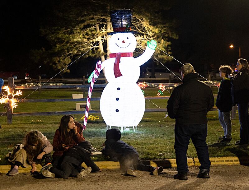 Visitors wait to ride horse-drawn carriages Saturday, Nov. 25, 2023 through the holiday light display at Centennial Park in Rock Falls. The lighted display officially opened on Nov. 24 and will run every Friday, Saturday and Sunday until Dec. 23.
