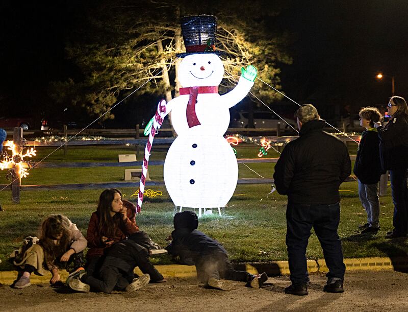 Visitors wait to ride horse-drawn carriages Saturday, Nov. 25, 2023 through the holiday light display at Centennial Park in Rock Falls. The lighted display officially opened on Nov. 24 and will run every Friday, Saturday and Sunday until Dec. 23.
