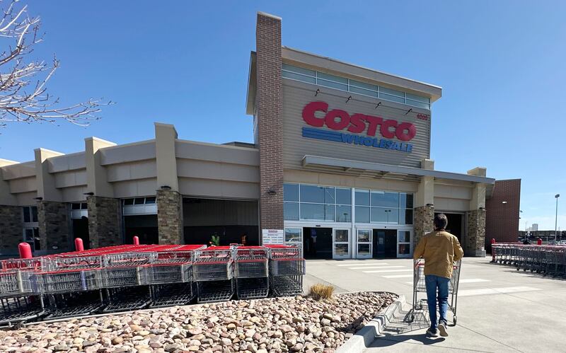 FILE - A lone shopper pushes a cart toward the entrance of a Costco warehouse, March 13, 2025, in Sheridan, Colo. (AP Photo/David Zalubowski, File)