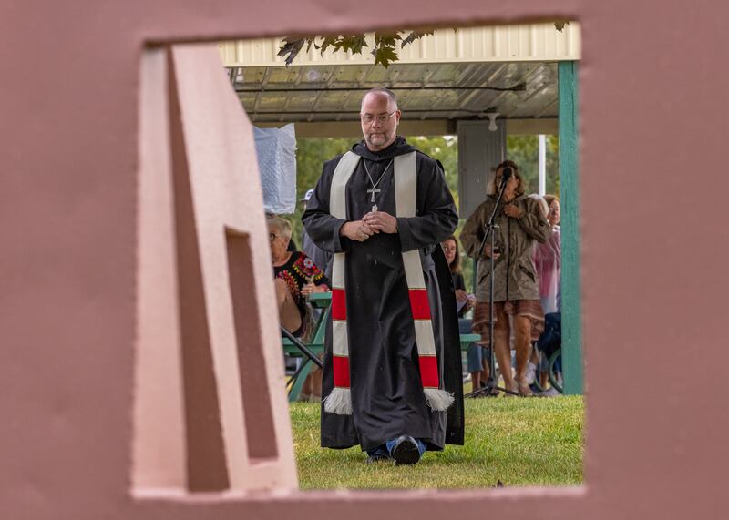 Abbott Michael Calhoun approaches the newly installed "Grazing Cattle" sculpture by renowned artist The Rev. Joseph Heyd of Saint Bede Abbey for blessing after prayer at the river front on September 20, 2025 in Hennepin.