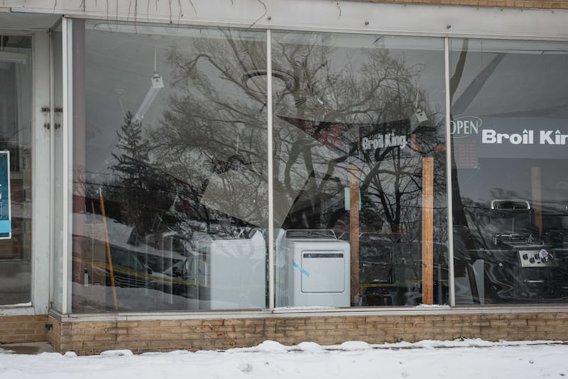 Parts of the roof that fell into Thompson's Appliances in Woodstock can be seen through the windows following a partial roof collapse on Dec. 3, 2025.