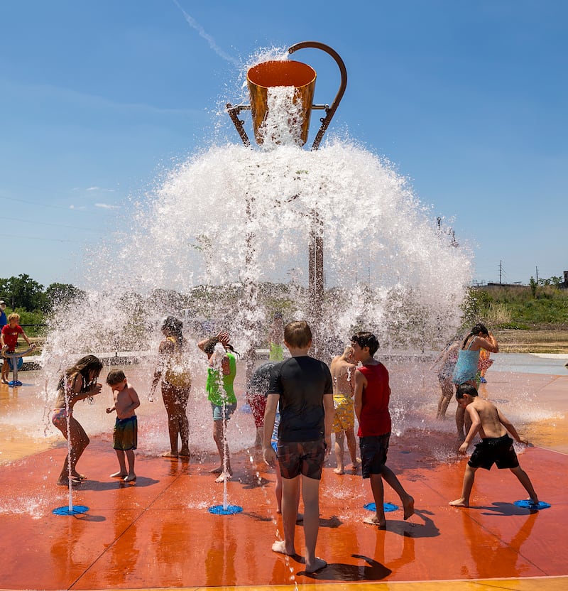 Kids keep cool at the splash pad at Northwestern Steel and Wire Park on Tuesday, June 2, 2026, as large crowds wait for the arrival of the Big Boy steam locomotive. A ribbon cutting for the park will begin at 11 a.m. June 13.
