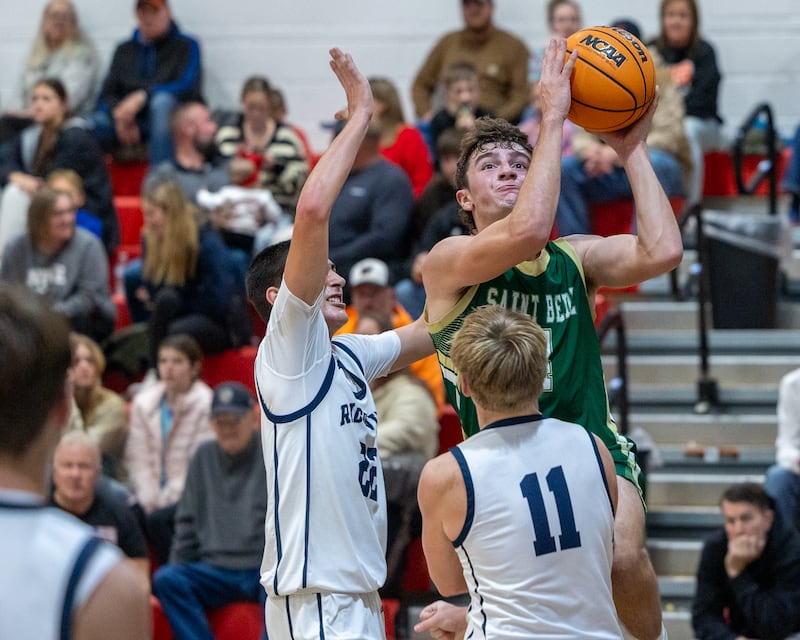 Gino Ferrari (4) of St. Bede shoots lays up ball as Landon Ludwig (22) and Cole Kennedy (11) of Ridgeview attempt to guard on Wednesday, November 26, 2025 at Woodland High School in South Streator.