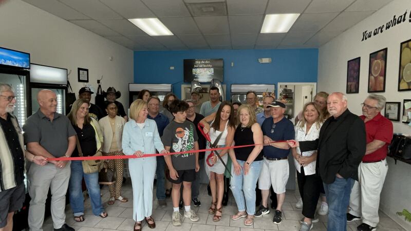 Angie Aegerter cuts the ribbon on May 13 at the Fit Foundation in Crest Hill, during a ceremony hosted by the Joliet Region Chamber of Commerce & Industry in honor of Aegerter's 10th anniversary of her Fit Foundation meal prep business.