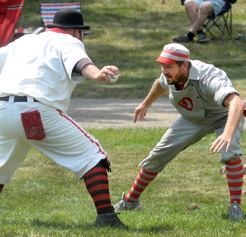 Oregon Ganymede Brett Rogers eyes the Bay City Independent catcher as he tries to avoid the tag at home during the World Tournament of Historic Base Ball held at the Henry Ford Museum's Greenfield Village on Saturday, Aug. 9, 2025.