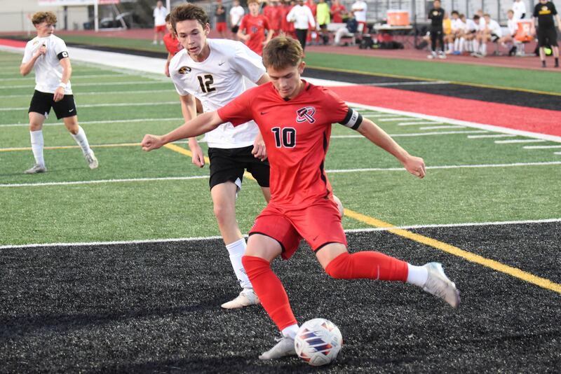 Bradley-Bourbonnais' Bennett Dykstra (10) crosses the ball in front of Herscher's Ashton Mayers during a game at Bradley-Bourbonnais Thursday, Sept. 11, 2025.