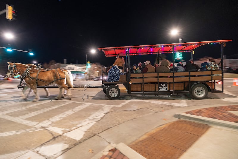 Riders take a tour of the downtown Friday, Dec. 6, 2024, on a horse drawn carriage during Sterling’s Sights and Sounds Christmas event.