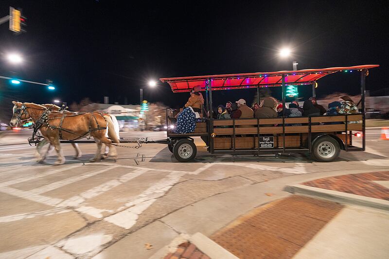 Riders take a tour of the downtown Friday, Dec. 6, 2024, on a horse drawn carriage during Sterling’s Sights and Sounds Christmas event.