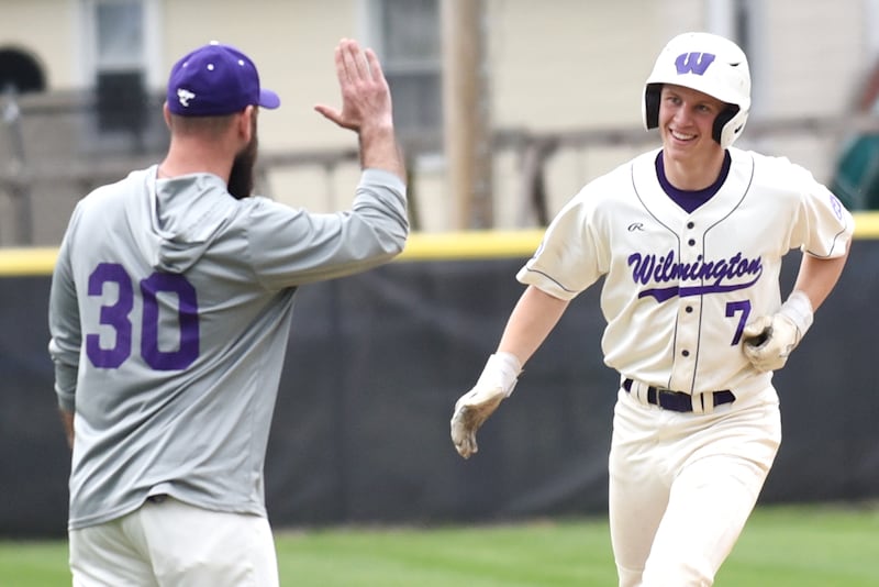 Wilmington's Cooper Holman, right, is congratulated by coach Mike Bushnell as he rounds third base following his home run during a home game against Manteno Tuesday, April 21, 2026.