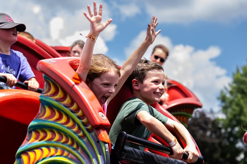 Plainfield residents Kylie and Noah Biddinger ride a rollercoaster at Plainfield Fest, presented by the Plainfield Riverfront Foundation, on June 29, 2025.