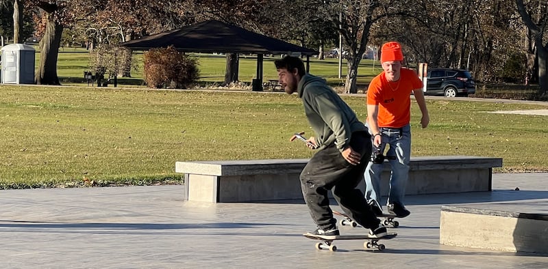 Nico Positano, 29, completed a line, with Wray Martin filming, at the Sycamore skatespot on Nov. 15, 2025, while holding a freshly grilled hot dog in tongs.