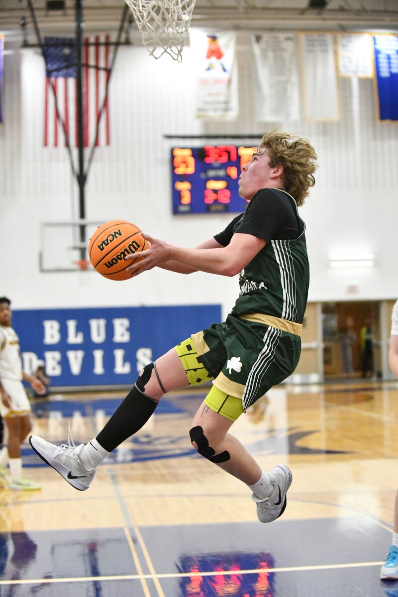 Bishop McNamara's Trey Provost maneuvers below the basket for a layup during the Fightin' Irish's 79-67 victory over Joliet Catholic Academy in the IHSA Class 2A Peotone Sectional semifinal on March 4, 2025.