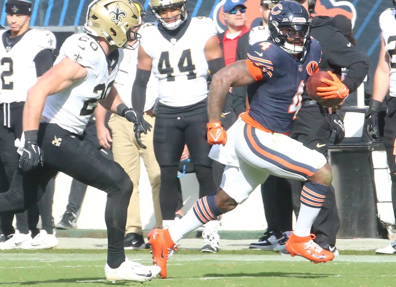 Chicago Bears running back D'Andre Swift sprints down the sidelines as New Orleans Saints linebacker Pete Grupe chases after hin on Sunday, Oct. 19, 2025 at Soldier Field in Chicago.